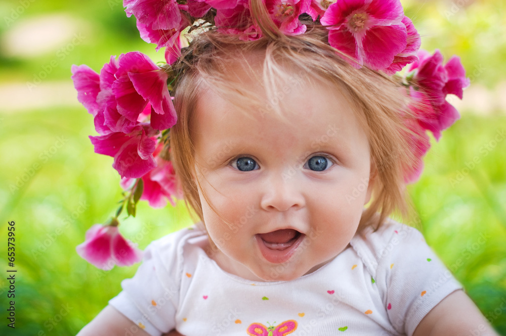 smiling baby in a wreath of flowers smiling baby in a wreath of flowers