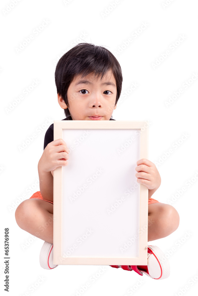 Portrait of a little boy holding a whiteboard over white backgro Portrait of a little boy holding a whiteboard over white backgro