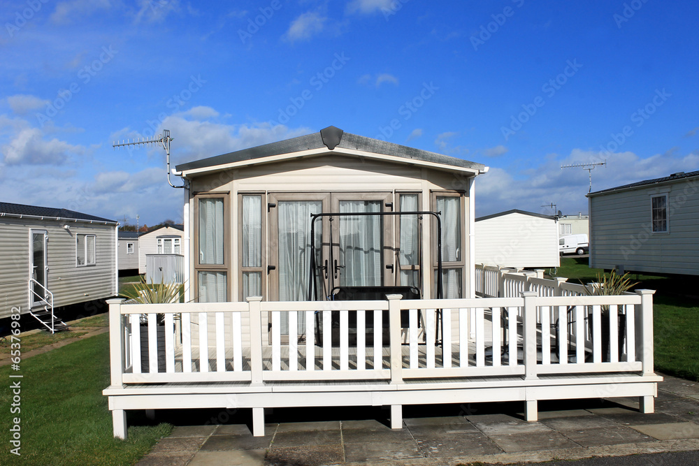 A modern white caravan on a trailer park.