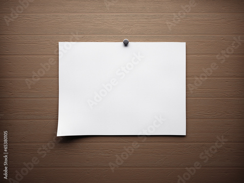 piece of blank paper tacked to wooden background