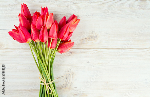 Fototapeta Naklejka Na Ścianę i Meble -  bunch of red tulips on wooden surface