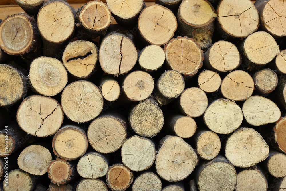 Background of dry chopped firewood logs stacked up on top of eac Background of dry chopped firewood logs stacked up on top of eac