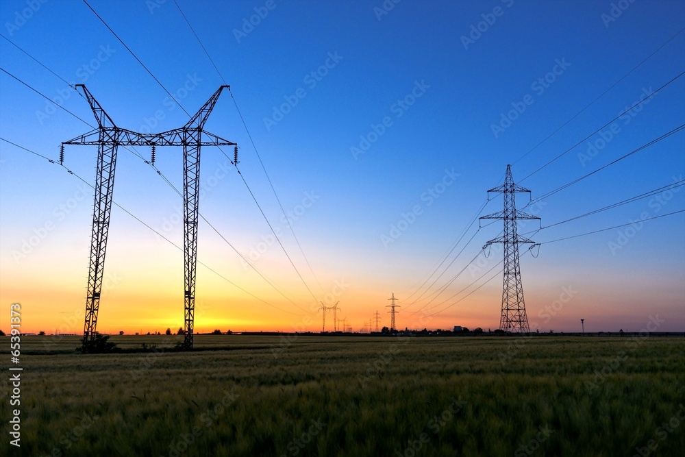 Tall power lines at dusk