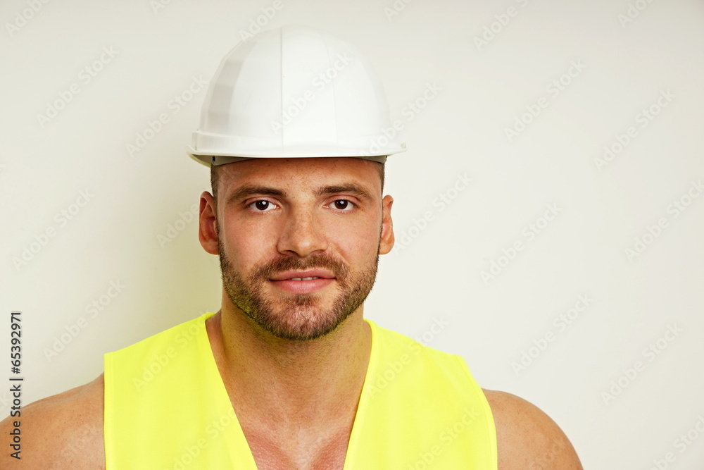 Portrait of big worker at protective helmet Portrait of big worker at protective helmet
