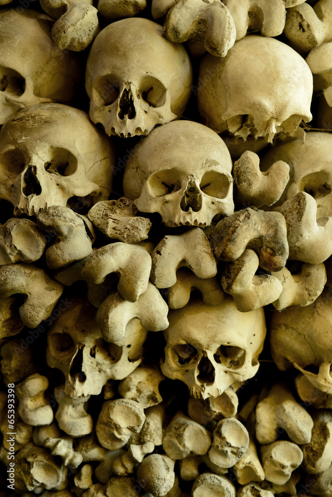 Human skulls and bones in the wall of Skull Chapel in Czermna - obrazy, fototapety, plakaty 