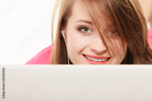 Girl with headphones and laptop listening to music