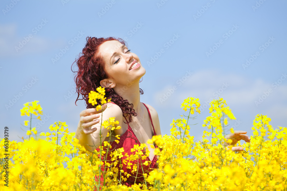 Woman enjoying in a rape field Woman enjoying in a rape field