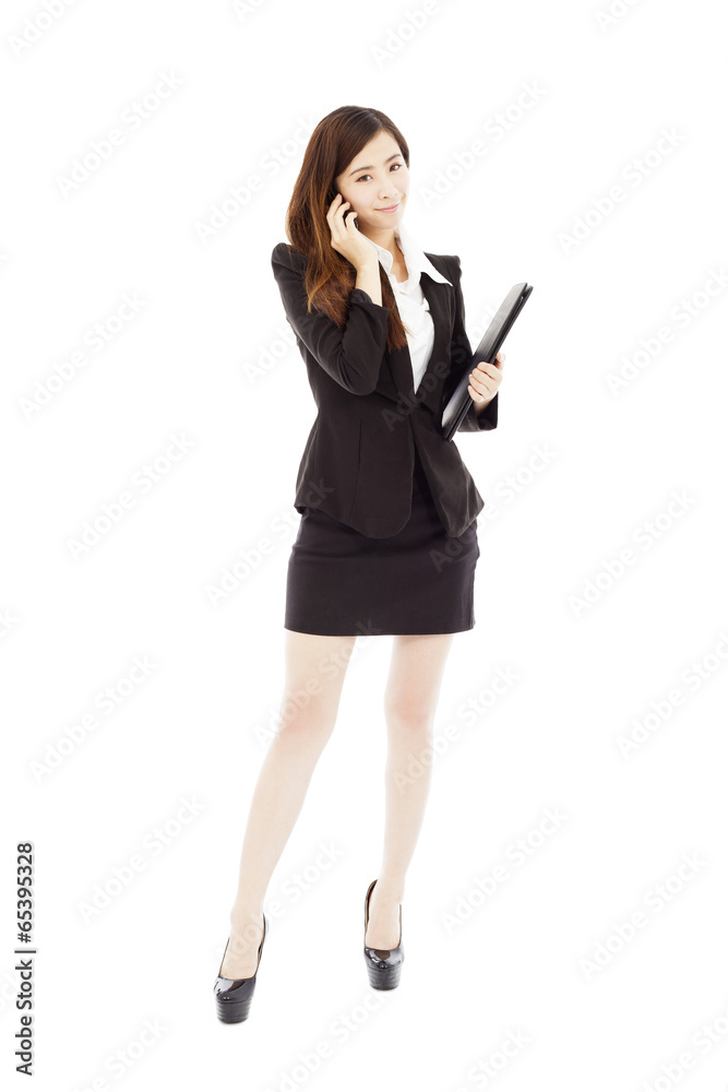 smiling businesswoman are talking by smartphone while walking