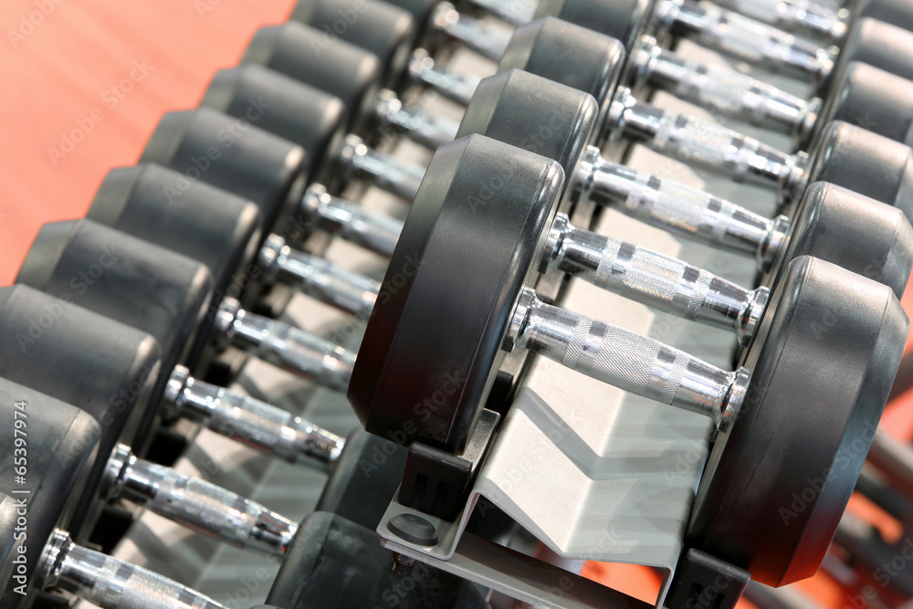 Fototapeta premium Dumbbells weights lined up in a fitness studio