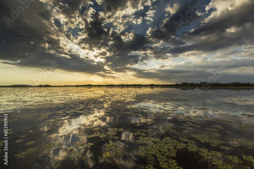 Ominous stormy sky reflection over natural lake