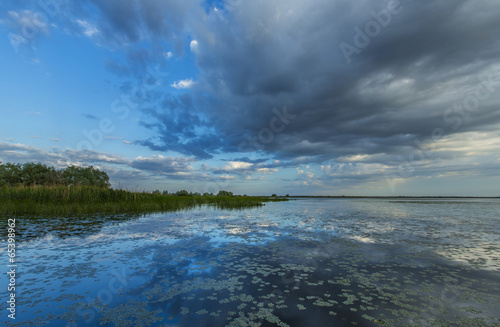 Ominous stormy sky reflection over natural lake