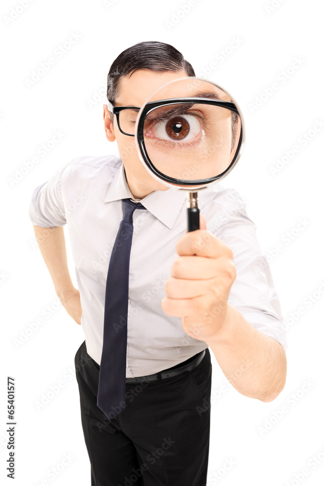 Man looking through a magnifying glass - obrazy, fototapety, plakaty 