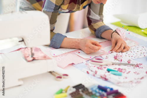 Closeup on seamstress working in studio