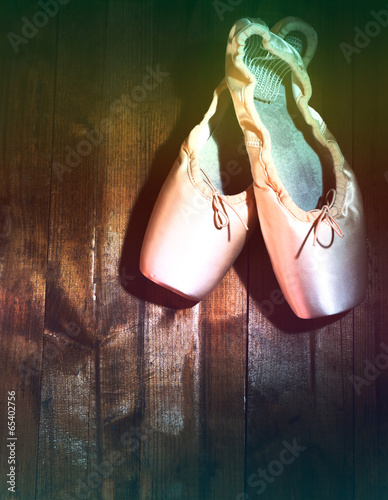 Ballet pointe shoes on wooden background © Africa Studio