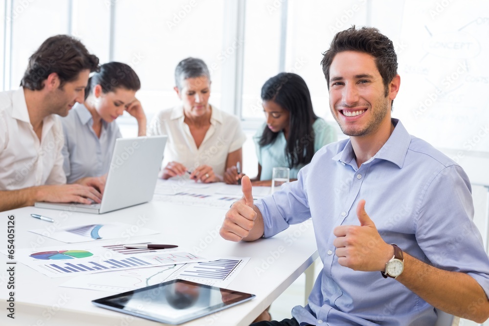 Attractive businessman smiling in the workplace Attractive businessman smiling in the workplace