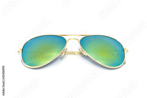 Gold sun glasses have a lens glass green yellow reflecting on an