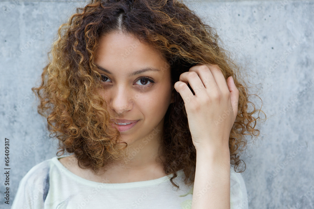 Fototapeta premium Elegant young woman posing with hand in hair