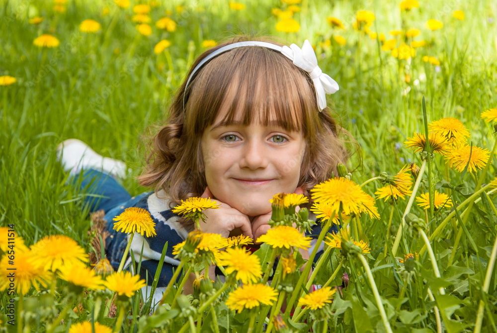 Pretty smiling girl on meadow with dandelions Pretty smiling girl on meadow with dandelions