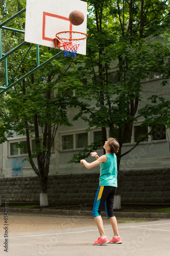 Obraz na płótnie Young girl shooting a goal in basketball w salonie