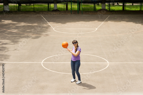 Middle aged woman playing a game of basketball © kolotype