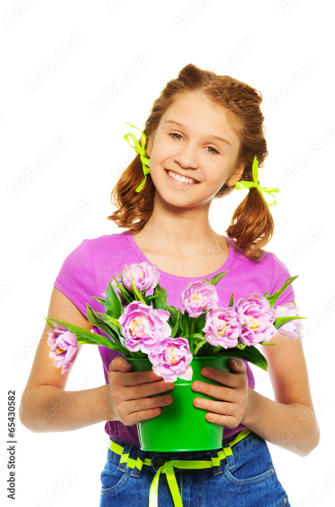 Smiling girl holding pail with pink tulips Smiling girl holding pail with pink tulips