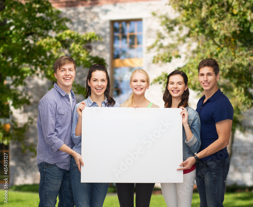 group of standing students with blank white board © Syda Productions