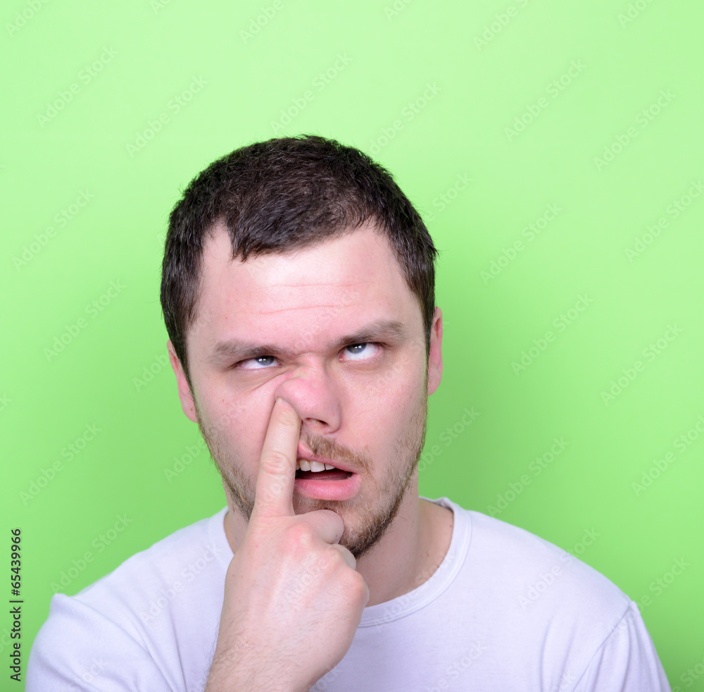 Portrait of a funny guy with finger in his nose