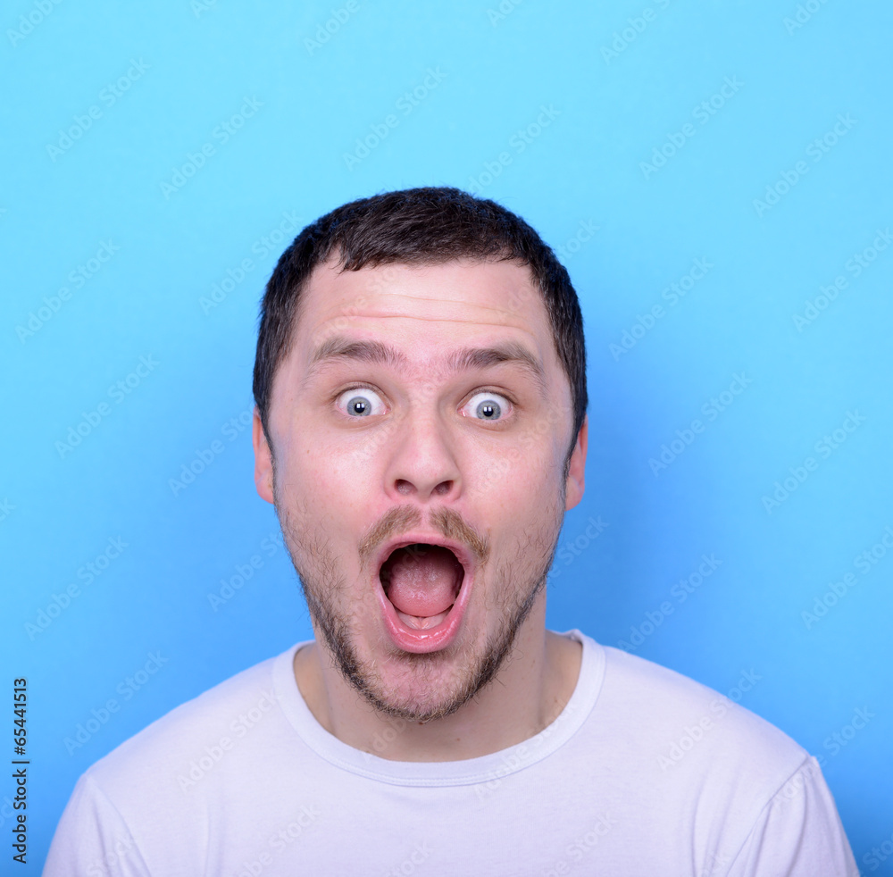 Portrait of man with funny face against blue background Portrait of man with funny face against blue background