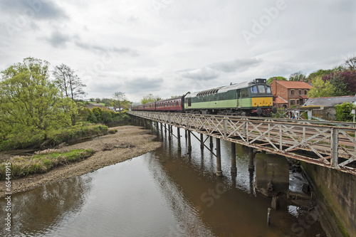 English train on travelling on bridge over a river © Paul Vinten