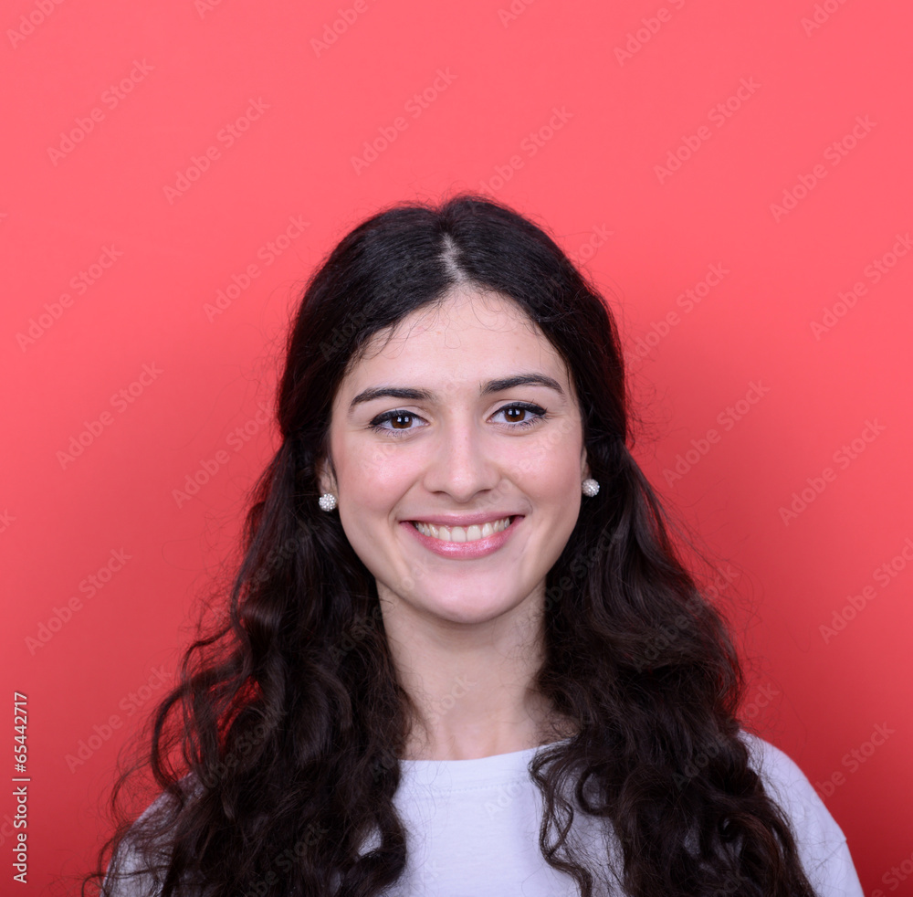 Portrait of beautiful young woman smiling against red background Portrait of beautiful young woman smiling against red background