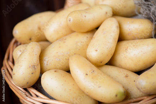 Close-up of raw potato in a basket, horizontal shot