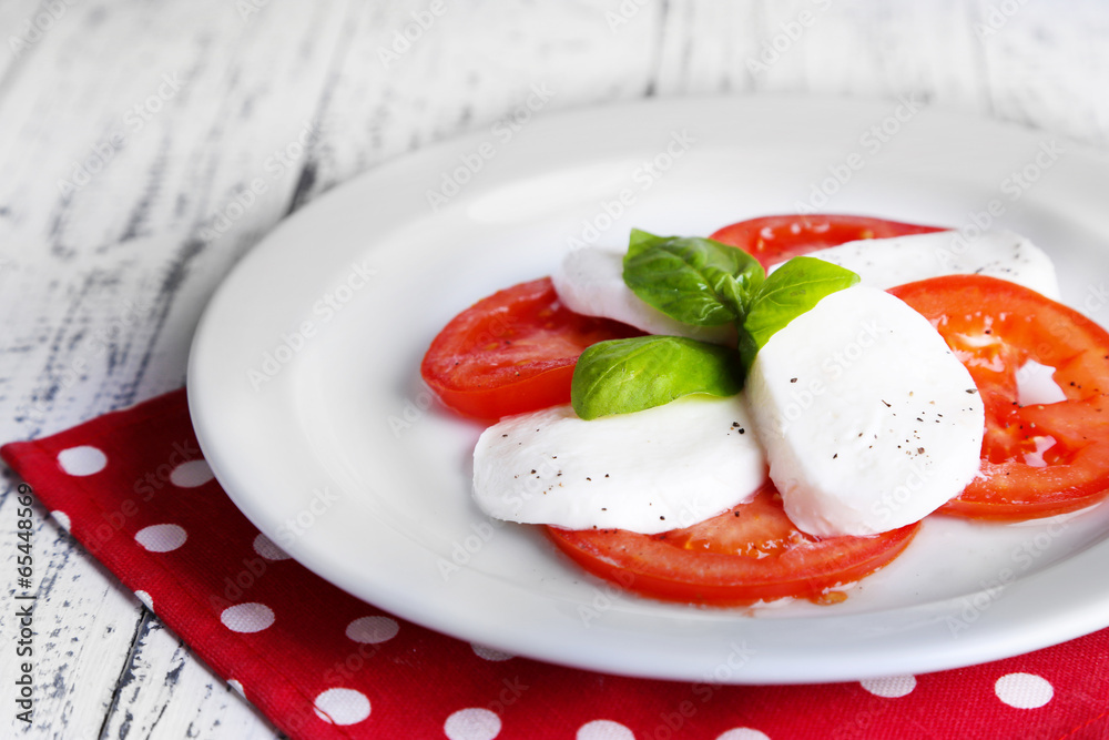 Caprese salad with mozarella cheese, tomatoes and basil Caprese salad with mozarella cheese, tomatoes and basil