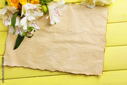 Fototapeta Naklejka Na Ścianę i Meble -  Beautiful Alstroemeria flowers and empty sheet on wooden table