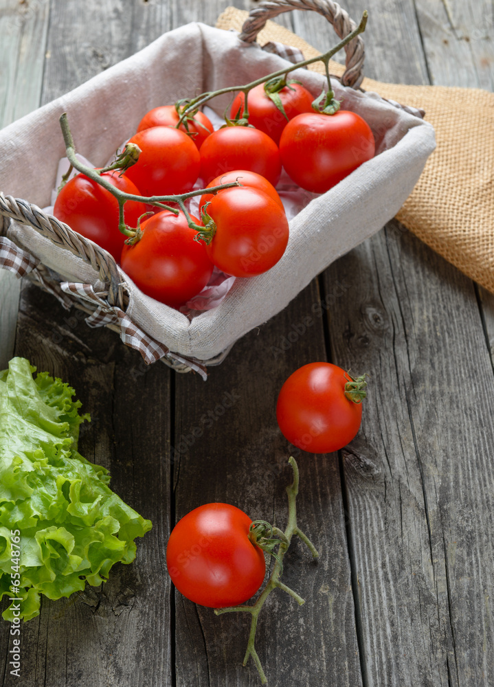 Tomatoes and salad on old grey wood