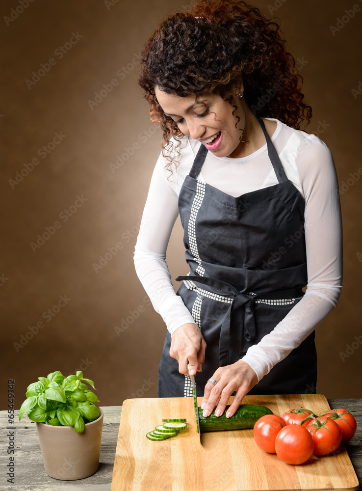 Happy Woman Cooking. Healthy Food - Fresh cucumber