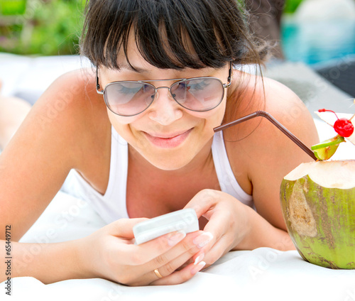 Smiling young woman with telephone