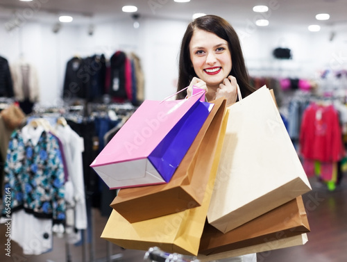 Ordinary female buyer with shopping bags