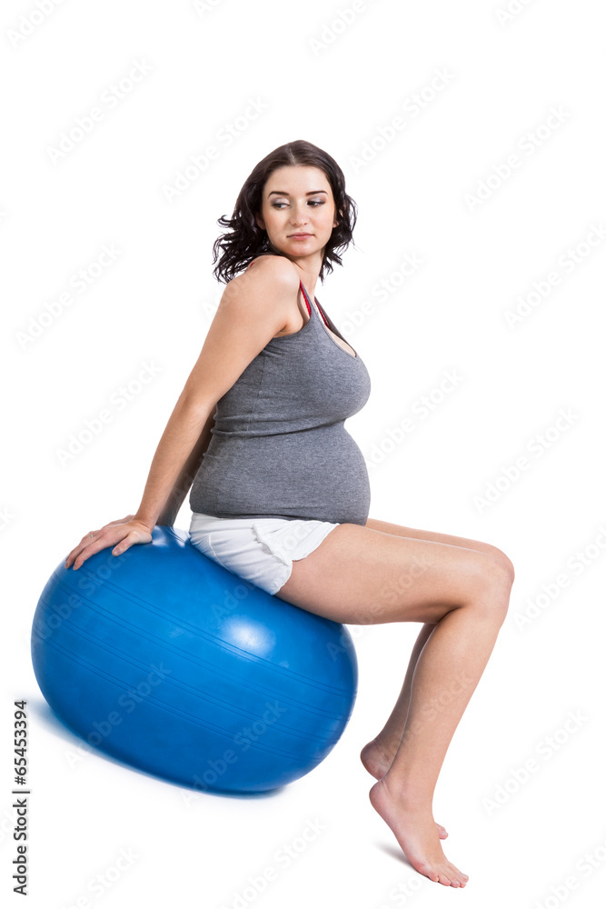 Pregnant woman doing pilates exercises Pregnant woman doing pilates exercises