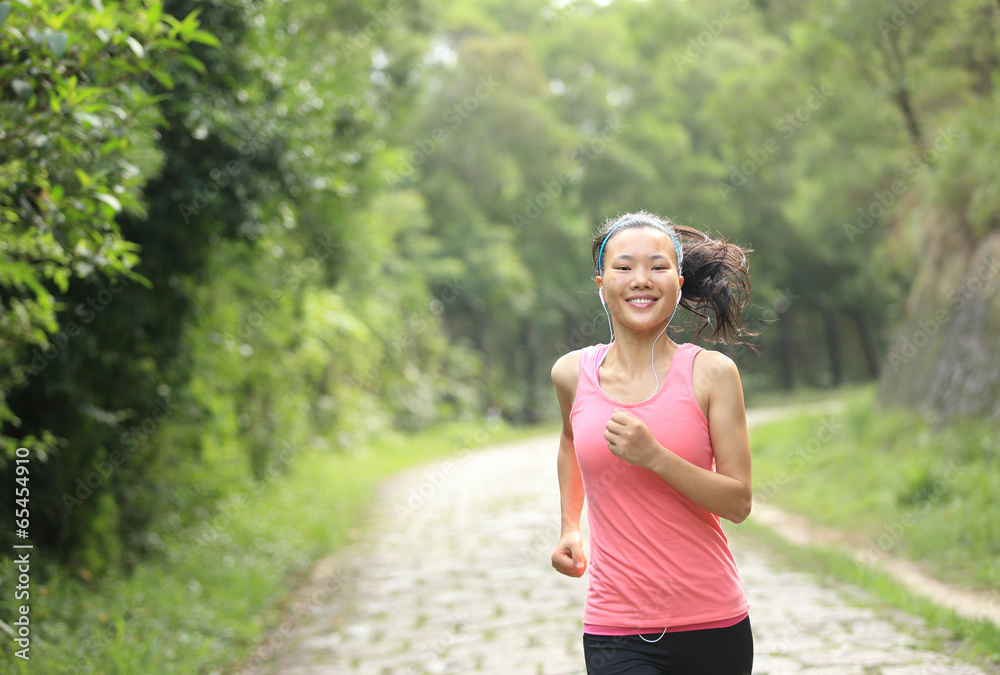 woman runner athlete running on forest trail woman runner athlete running on forest trail