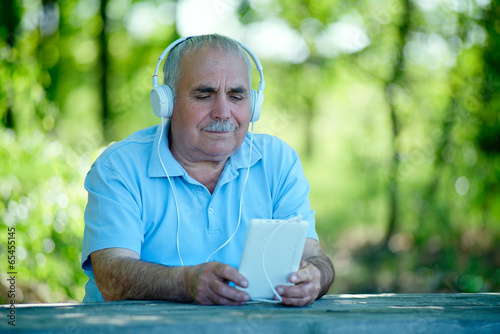 Senior man searching for a tune on his MP3 player