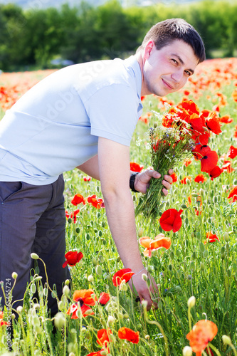 Young man with bouquet of poppies © _chupacabra_