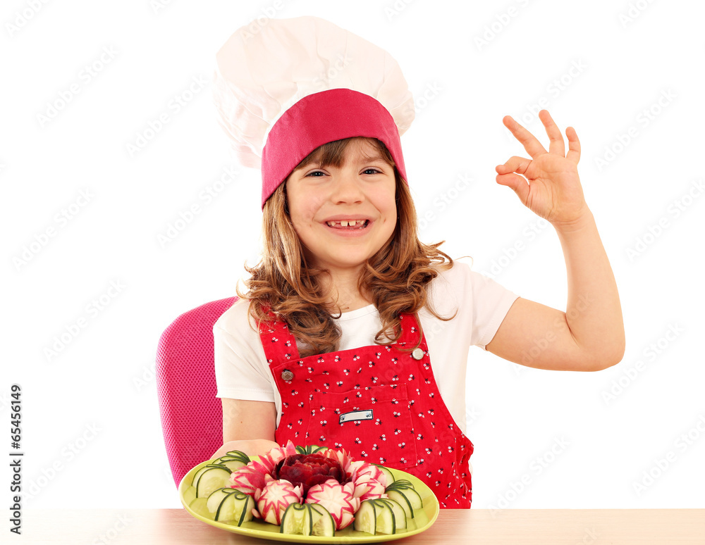 happy little girl cook with ok hand sign and decorated salad
