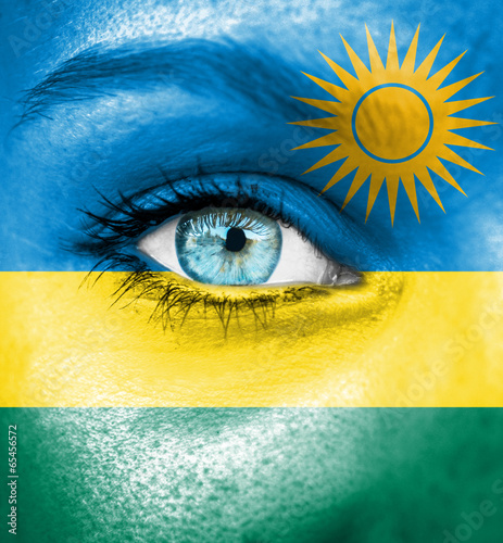 Woman face painted with flag of Rwanda