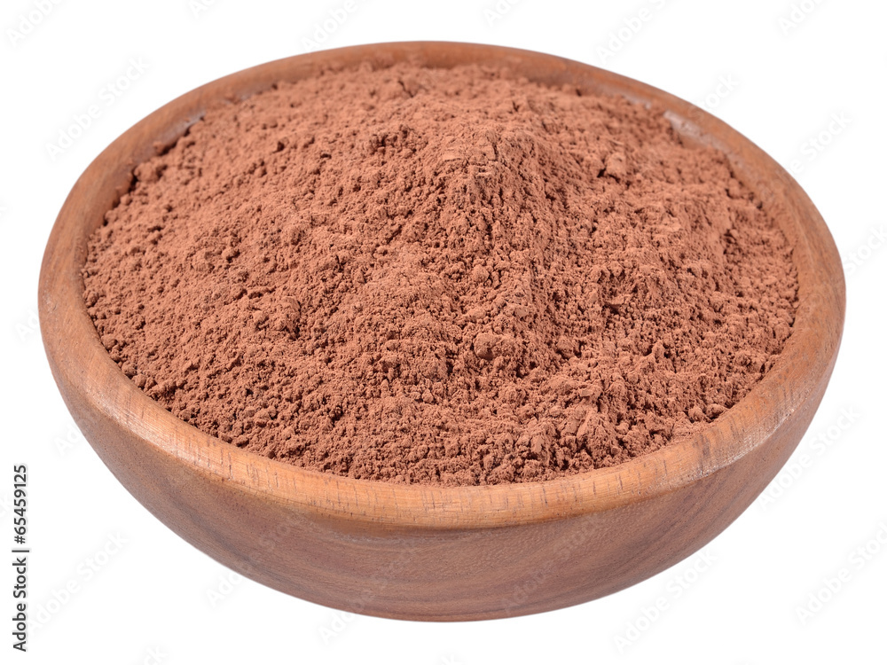 Cocoa powder in a wooden bowl on a white Cocoa powder in a wooden bowl on a white