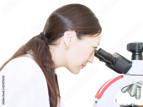 Portrait of young asian girl doctor looking to microscope in lab