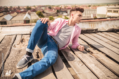 casual man in a fashion pose lying down