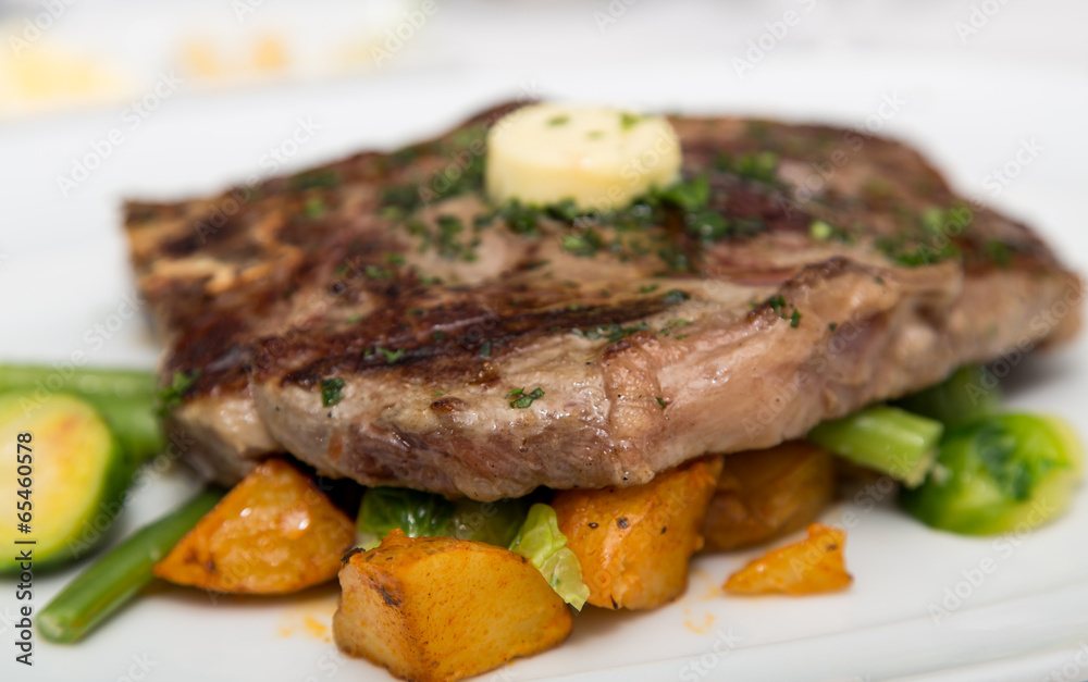 Sirloin Steak with Butter on Vegetable Garnish Sirloin Steak with Butter on Vegetable Garnish