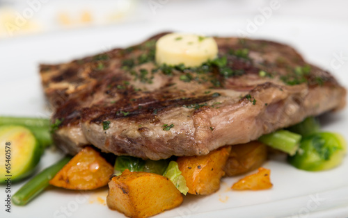 Sirloin Steak with Butter on Vegetable Garnish