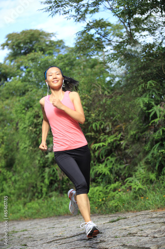 woman runner athlete running on forest trail