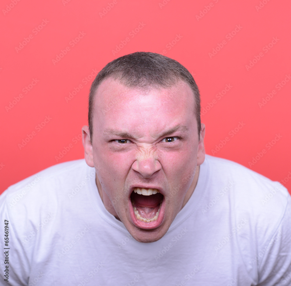 Portrait of angry man screaming against red background Portrait of angry man screaming against red background